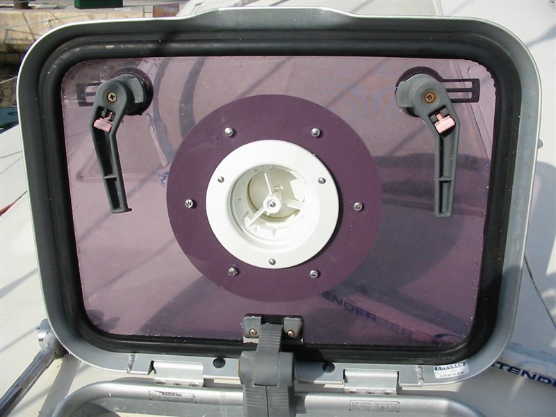 An Air-Only vent fitted through the tinted lens of an open deck hatch, held by a round mounting ring